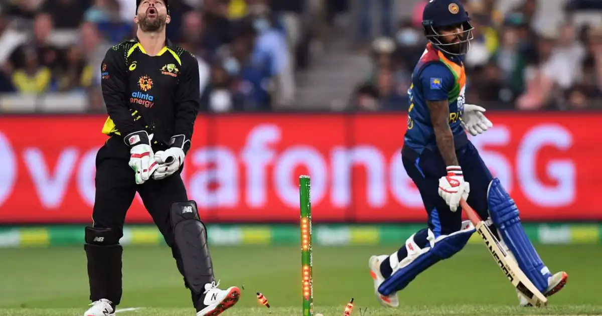 Matthew Wade attempts a run-out against Kusal Mendis during an international T20 match.